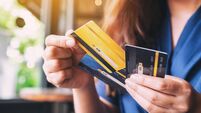 a woman holding and choosing credit card to use