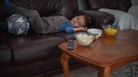 A little boy is watching football on TV at home