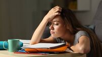 Tired student trying to study in the night