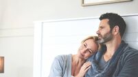 A couple relaxing in bed at home. A mature man and woman in love, resting and thinking in the bedroom during the morning