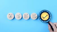 Quality Control and Certification Assurance Concept. Hand holding magnifying glass over checkmark symbol, alongside icons repres