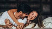 Happy young couple in bed