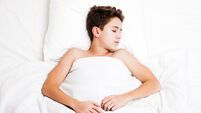 Happy handsome sleeping child boy lying bed and resting