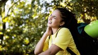 Hiker female in wood area having problems with mosquitos