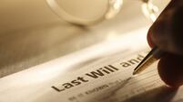 Man signing last will and testament