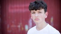 Head And Shoulders Portrait Of Serious Teenage Boy
