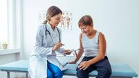 Smiling doctor showing diet plan