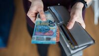Woman taking out money from wallet