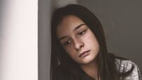Depressed teenager sitting lonely