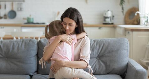 Loving mother hugging, comforting little daughter, enjoying tender moment