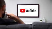 YouTube on TV. Man with a mug and watching a smart television with a You Tube Logo on the screen. ROSARIO, ARGENTINA - MARCH 23,
