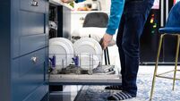 Open Dishwasher Filled With Dirty Plates
