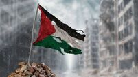Dirty and torn Palestine flag, symbol of resistance and victory. A scene of war and devastation, the ruins of a city destroyed b