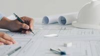 Close-up Of Engineer Hand Drawing Plan On Blue Print with architect equipment,architectural plan, sketching a construction proje